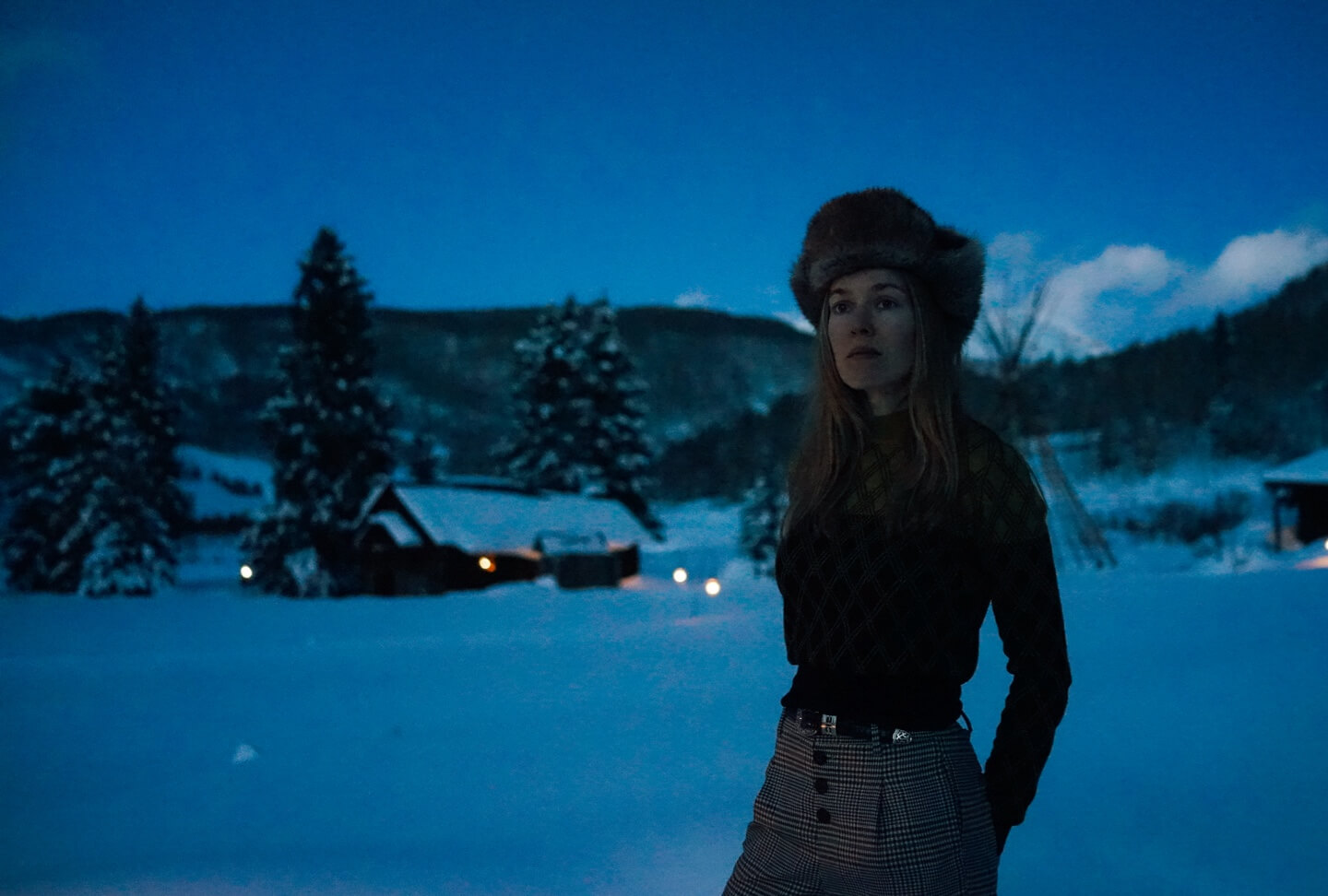 Woman gazing across snowy landscape